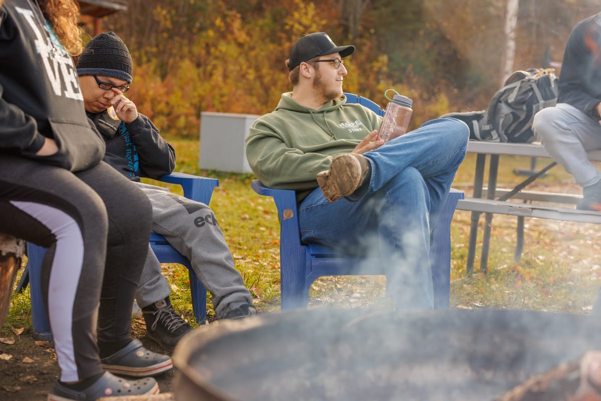Chi Alpha students sitting round a fire pit