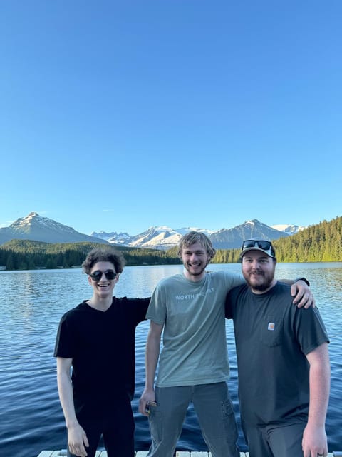 Three Chi Alpha students arm in arm on the dock at Auke Lake