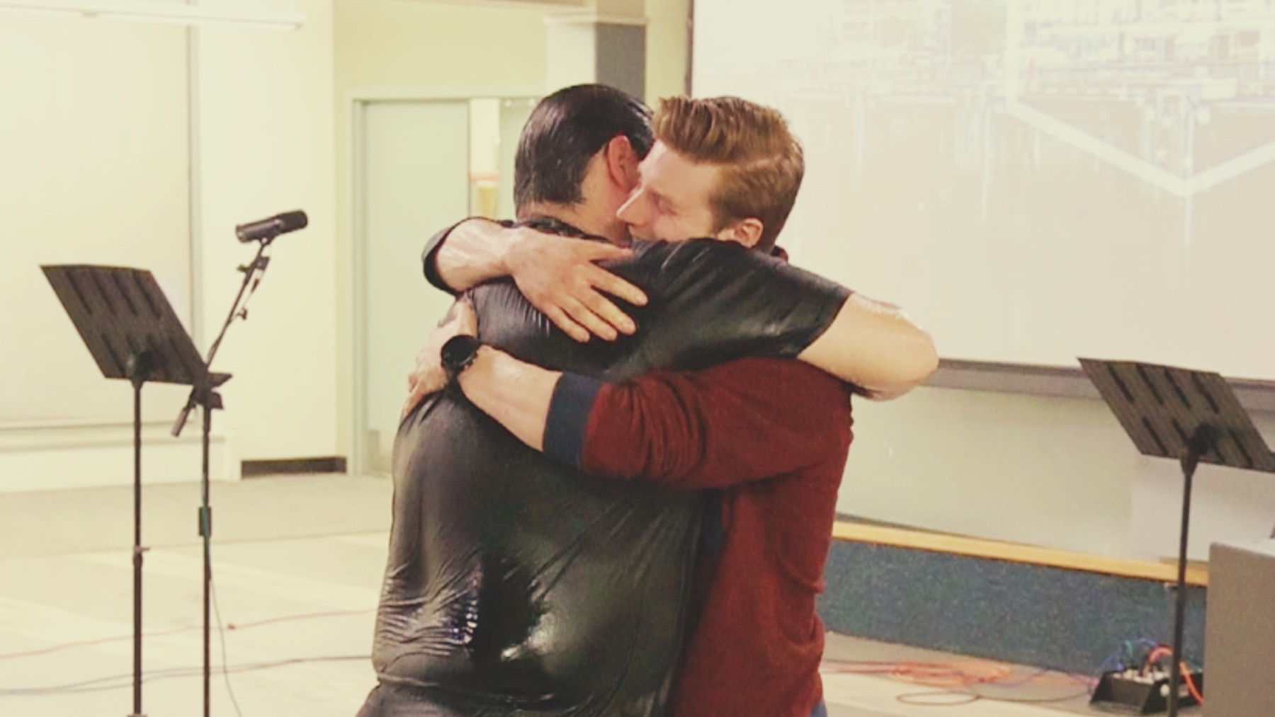 Two students embracing at a Chi Alpha gathering